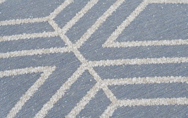 Contemporary Macy Bluestone Pouf with blue polyester fabric and textured geometric pattern, offering a stylish, durable footrest or seat.