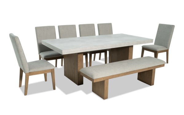 Monterey 8 Piece Natural & Gray Dining Set with faux concrete melamine table top, six gray fabric-upholstered memory foam chairs, and matching bench.