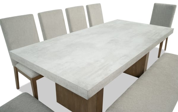 Monterey 8 Piece Natural & Gray Solid Back Upholstered Dining Set with bench, gray polyester fabric chairs, faux concrete melamine tabletop, traditional style.