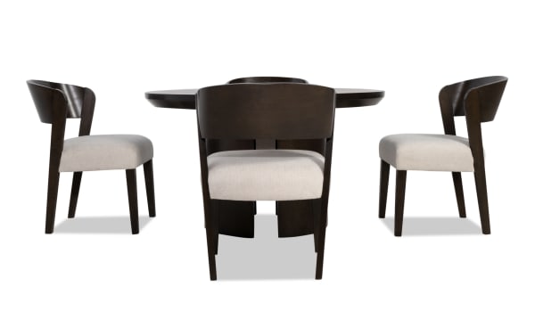 Dark wood dining table set with beige upholstered seats and curved backrests, featuring modern mid-century style chairs.