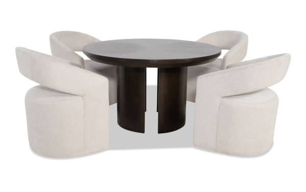 Round dark wood dining table with four beige upholstered swivel chairs featuring curved backs and modern design.