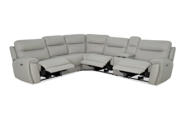 Illusion Gray Leather 128" power reclining 6-piece sectional with power headrests, gray leather upholstery, built-in cupholders, drop-down table, USB ports, and wireless charging.