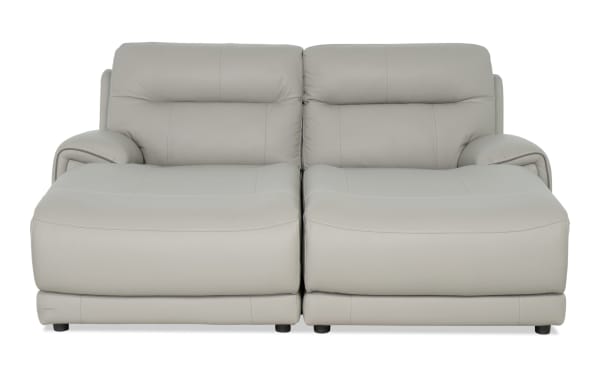 Illusion Gray Leather 82'' Power Reclining Dual Chaise with Power Headrest in gray transitional style, featuring plush leather upholstery and wide cushioned seats.