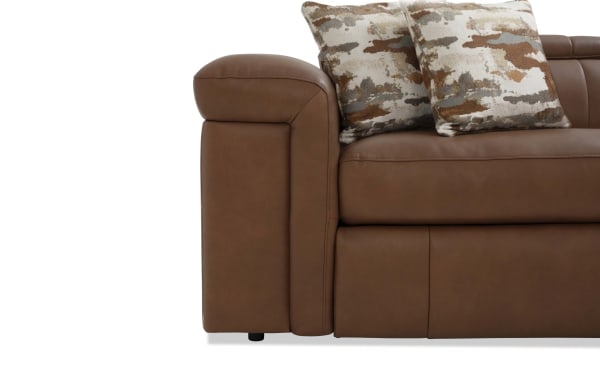 Contemporary Cannon Cognac leather sectional armrest with plush Bob-O-Pedic memory foam cushions and two patterned accent pillows.
