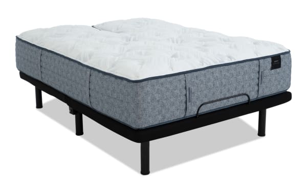 Queen-size mattress with a plush white quilted top and textured gray fabric sides, supported by a black metal bed frame with legs.