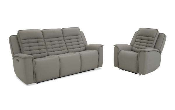 Modern gray leather reclining sofa set with three seats and matching single recliner chair, featuring padded backrests and armrests for living room comfort.