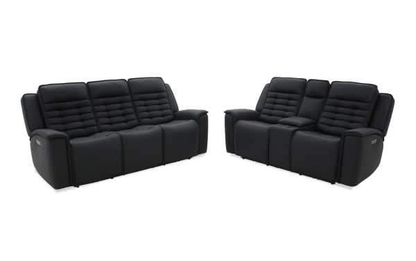 Black leather reclining sofas set with padded, segmented backrests and armrests; one sofa has a center console with cup holders and storage, ideal for home theater seating.