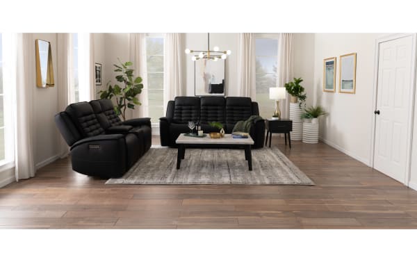 Raptor black leather 87'' power reclining sofa and 77'' console loveseat set with power headrest, lumbar support, USB ports, and contemporary style.