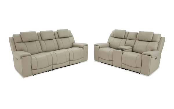 Beige leather reclining sofa set with three-seat and two-seat configurations, featuring padded armrests and adjustable headrests for living room comfort.