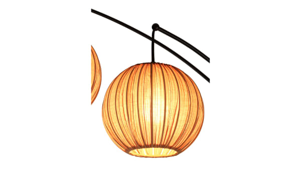 Hanging spherical lantern with warm orange fabric shade and vertical pleats, attached to curved black metal arm, providing ambient lighting.