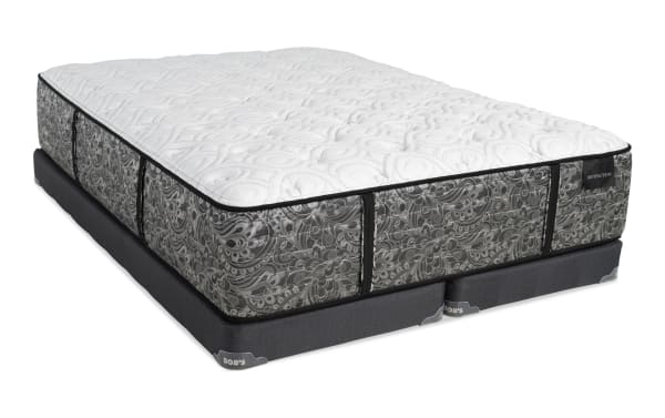 Queen-size mattress and foundation set with a white quilted top and gray patterned sides, featuring black trim and labeled "DISTINCTION" and "BOB'S" brand tags.
