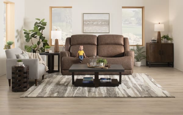 Contemporary Zeus Living brown 87" power reclining sofa with power headrest, polyester fabric upholstery, wide seat, high back, and modern design.