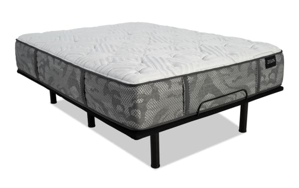Queen-sized Zeus mattress with gray patterned fabric sides and white quilted top, supported by a black metal bed frame with legs.