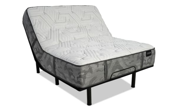 Adjustable Serta mattress with white quilted top and gray mesh sides on black metal frame, showing flexible head and foot elevation.