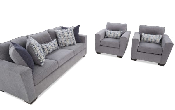 Modern gray fabric living room set featuring a three-seater sofa and two armchairs with patterned blue and gray accent pillows, ideal for contemporary home decor.