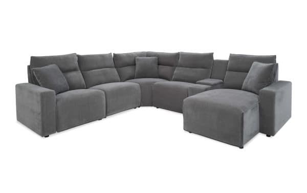 Modern gray fabric sectional sofa with plush cushions, corner design, and wide armrests, ideal for spacious living rooms.