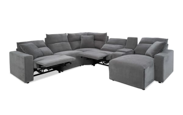 Modern gray fabric sectional sofa with reclining seats, adjustable footrests, and plush cushions, designed for comfort and style in living rooms.