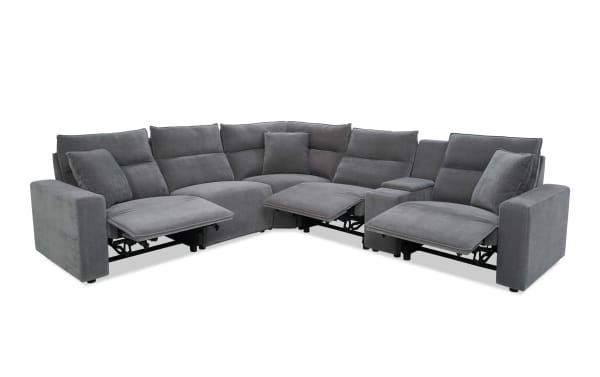 Modern gray fabric sectional sofa with three reclining seats, plush cushions, and wide armrests, designed for comfort and style in living rooms.