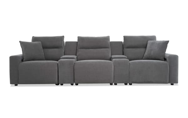 Modern gray fabric reclining sectional sofa with three seats, padded armrests, and two matching throw pillows, ideal for living room comfort.