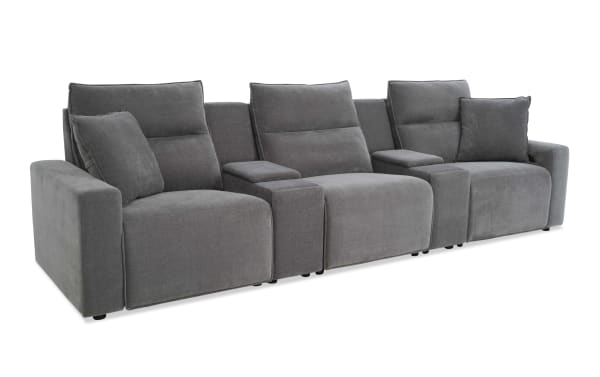 Modern gray fabric reclining sectional sofa with three seats, plush cushions, wide armrests, and built-in armrest storage compartments.
