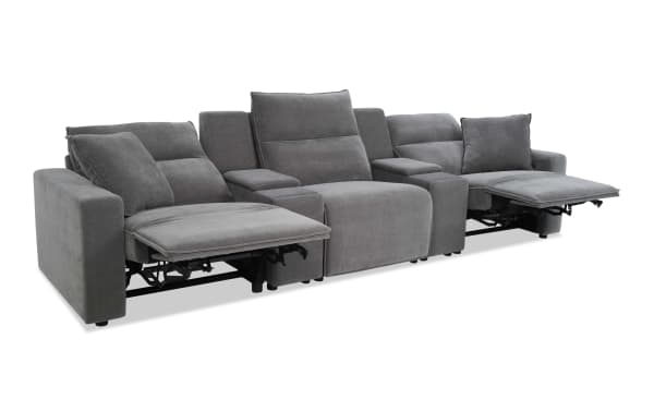 Gray fabric reclining sectional sofa with three seats, two reclining footrests, padded armrests, and cushioned back support, ideal for living rooms.