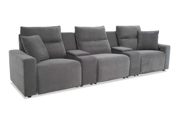 Modern gray fabric reclining sectional sofa with three seats, padded armrests, and cushioned backrests, designed for living room comfort.