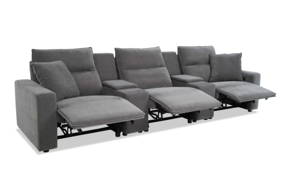 Gray fabric reclining sectional sofa with three seats, padded armrests, and cushioned backrests, designed for living room comfort and relaxation.