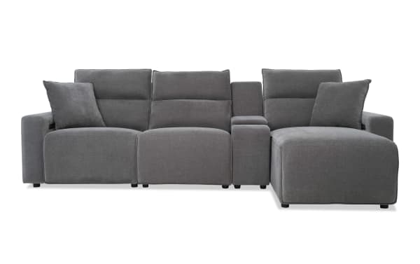Modern sectional sofa in dark gray fabric upholstery with adjustable headrests, plush cushions, and a built-in center console for living room comfort.