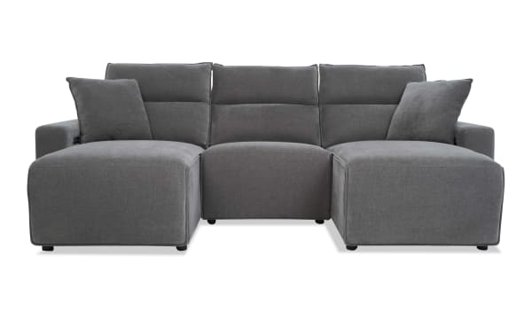 Modern gray fabric sectional sofa with chaise lounges on both ends, plush cushions, and a minimalist design for living room seating.