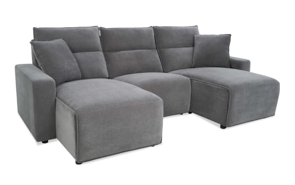 Modern gray fabric sectional sofa with chaise lounges on both ends, plush cushions, and a soft textured upholstery for living room comfort.