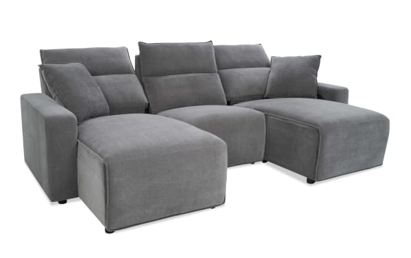 Modern gray fabric sectional sofa with adjustable backrests, chaise lounge, and plush cushions, designed for living room comfort and style.