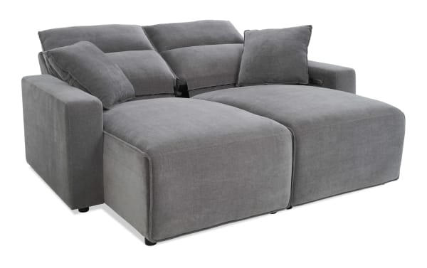 Modern gray fabric sectional sofa with plush cushions, wide armrests, and adjustable reclining backrests, ideal for living room comfort.
