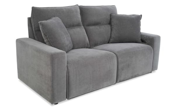 Modern gray fabric reclining loveseat sofa with plush cushions, wide armrests, and built-in control buttons for adjustable comfort.