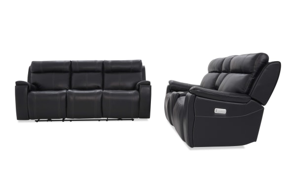 Black leather reclining sofa set with three seats, visible stitching, padded armrests, and side control panel for reclining functions.
