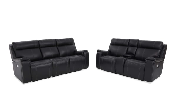Black leather reclining sofa set with contrast stitching, featuring a three-seat sofa and a two-seat loveseat with center console for living room comfort.