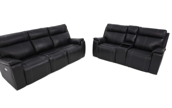 Black leather reclining sofa set with contrast stitching, featuring a three-seater and a two-seater with center console, modern living room furniture.