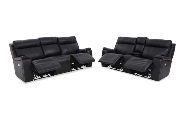 Black leather reclining sofa set with three seats each, featuring padded armrests, headrests, and visible stitching for modern living room comfort.