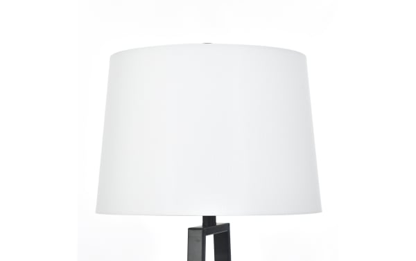Modern table lamp with a white fabric drum shade and a black geometric metal base, ideal for contemporary home decor.
