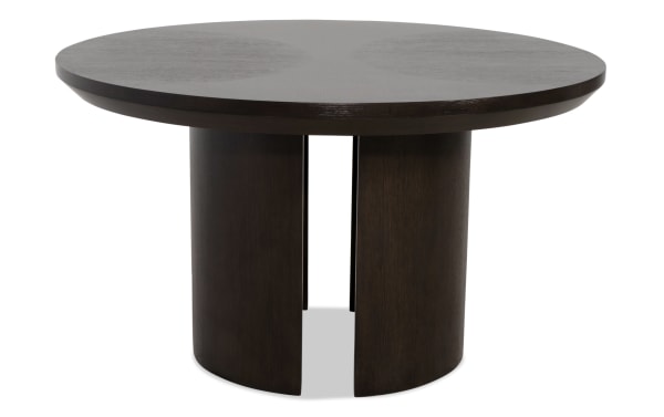 Round dark brown wooden dining table with a thick tabletop and a unique cylindrical base featuring vertical gaps, modern design.