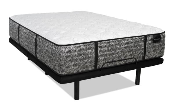 Mattress with a white quilted top and gray patterned sides on a black metal bed frame with legs, featuring the brand label "DISTINCTION."
