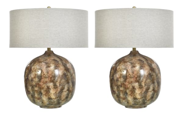 Pair of decorative table lamps with rounded, mottled brown and beige ceramic bases and large beige fabric drum shades, ideal for living room or bedroom lighting.
