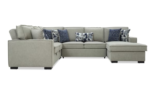 Gray fabric sectional sofa with chaise lounge, featuring multiple blue and patterned throw pillows, modern design with clean lines and black legs.