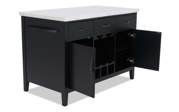 Black kitchen island with white marble countertop, featuring three drawers and two open cabinet doors revealing wine rack and storage shelves.