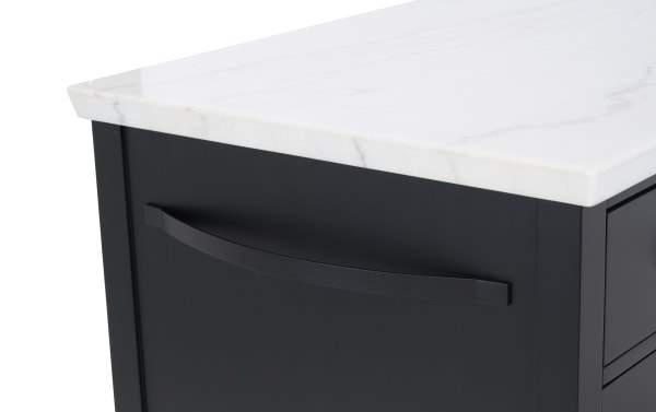 Black cabinet drawer with a curved black metal handle and a white marble countertop, showcasing modern kitchen storage design.