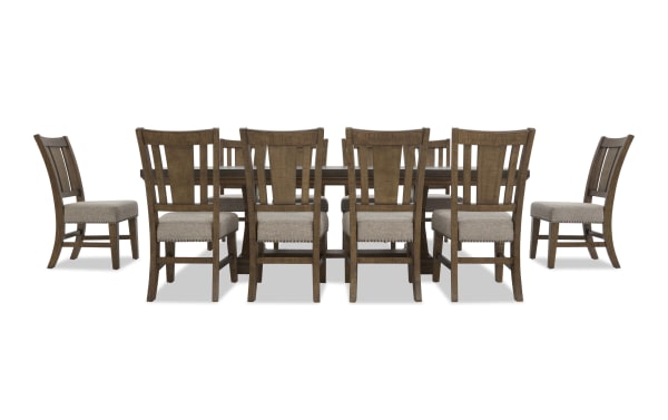 Dining set with a large rectangular wooden table and ten matching wooden chairs featuring beige upholstered seats and a classic slat back design.