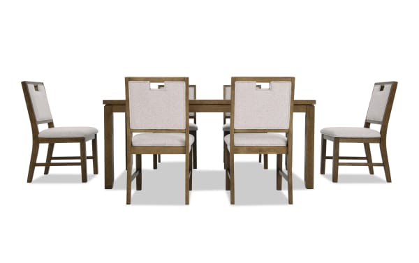 Dining set with six wooden chairs featuring beige upholstered seats and backs, paired with a rectangular wooden table in a natural finish.