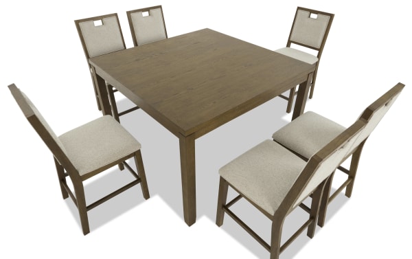 Square wooden dining table with six beige upholstered chairs, featuring a simple, modern design and sturdy wood construction.