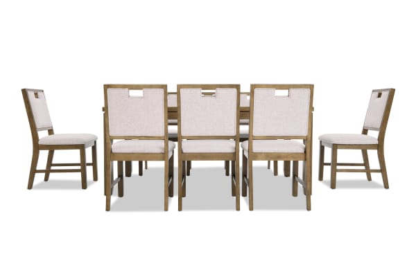 Dining set featuring a rectangular wooden table with a natural finish and six matching chairs upholstered in light beige fabric, showcasing a modern rustic style.