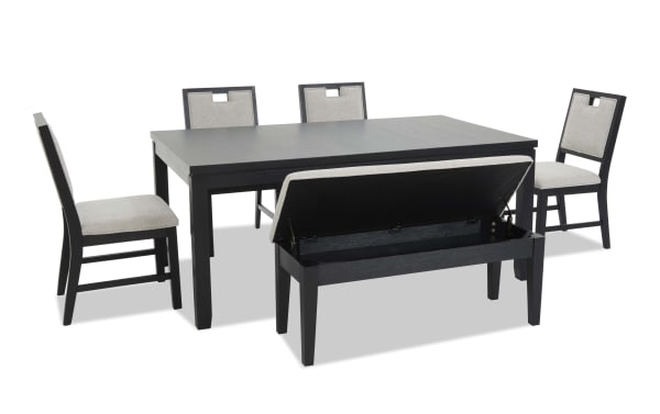 Dining set with black wood rectangular table, four beige cushioned chairs, and a beige cushioned storage bench with lift-up seat, modern style.