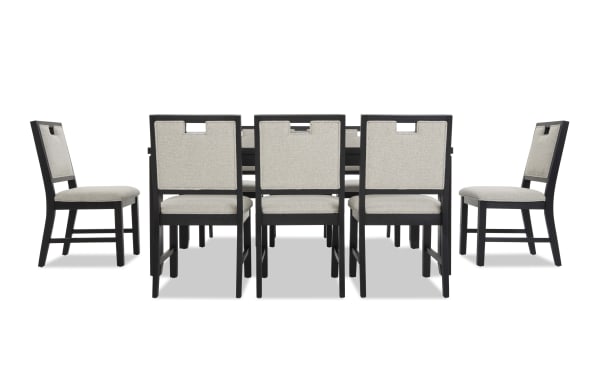 Dining set with eight chairs featuring black wooden frames and beige upholstered seats and backs, designed for modern dining rooms.
